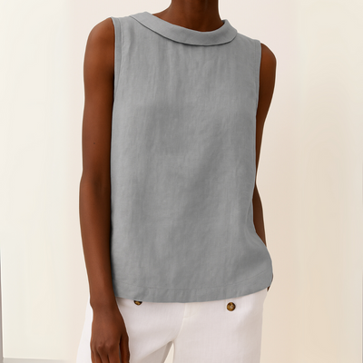 Light blue sleeveless top worn by a person on a beige background